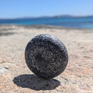 bamboo charcoal detox shampoo bar texture close up plastic free haircare at the ocean
