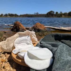 reusable bamboo makeup pads placed outdoors on rock eco friendly skincare
